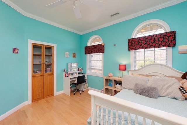 bedroom featuring visible vents, crown molding, baseboards, a ceiling fan, and light wood-style flooring