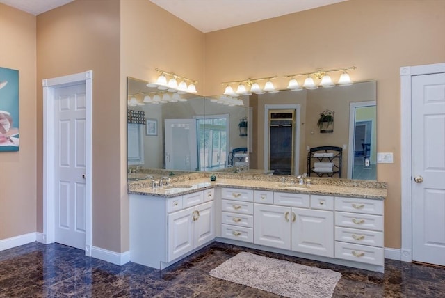 bathroom with a sink, baseboards, and marble finish floor