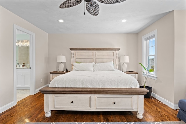 bedroom featuring ensuite bathroom, dark wood-style flooring, recessed lighting, and baseboards