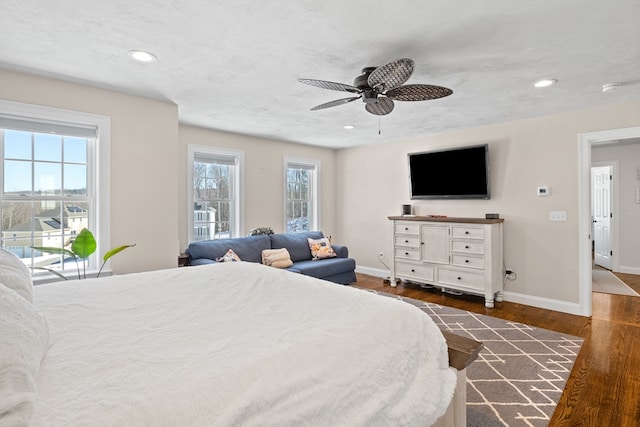 bedroom featuring dark wood-style floors, recessed lighting, baseboards, and a ceiling fan