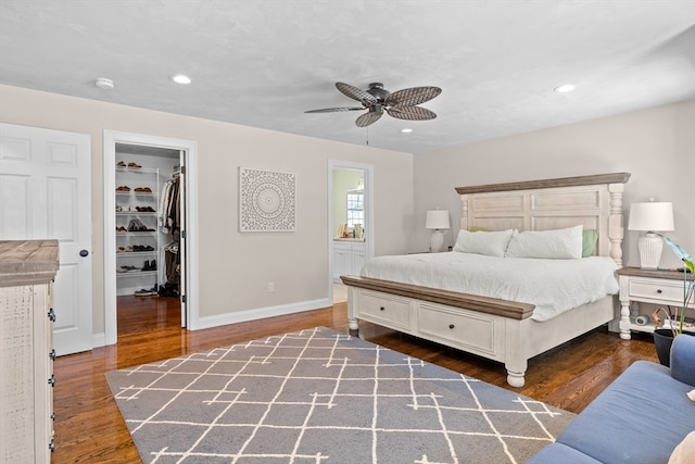 bedroom featuring a walk in closet, wood finished floors, and recessed lighting