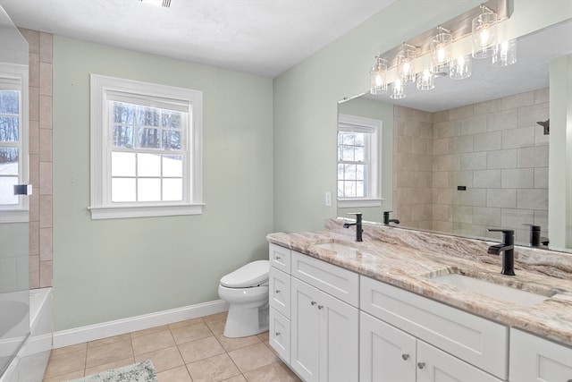 full bath featuring tile patterned flooring, baseboards, a sink, and toilet