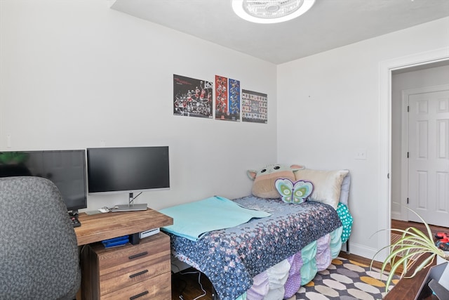 bedroom with baseboards and wood finished floors