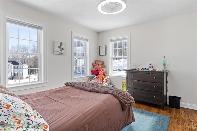 bedroom featuring wood finished floors and baseboards