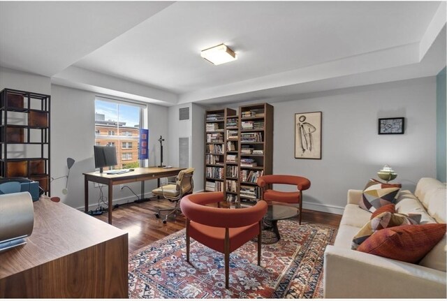 home office with hardwood / wood-style flooring