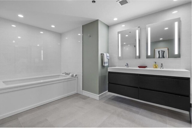 bathroom with a tub and vanity