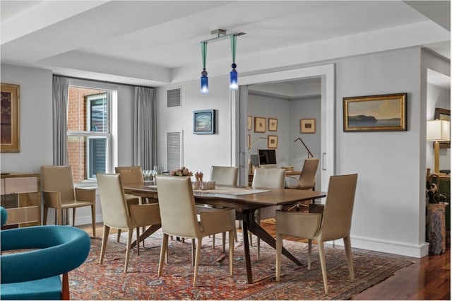 dining area featuring dark wood-type flooring