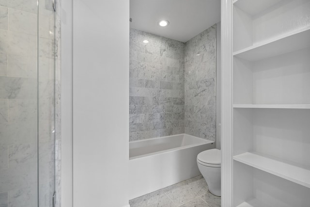 bathroom featuring toilet, tile patterned floors, built in shelves, and tiled shower / bath