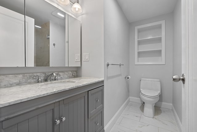 bathroom with toilet, vanity, and a shower