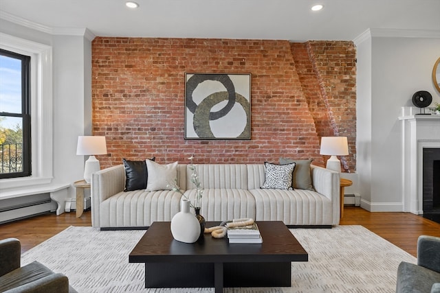 living room featuring brick wall, ornamental molding, and wood-type flooring