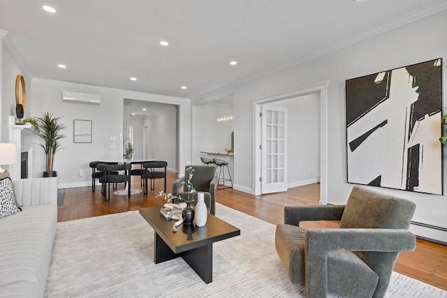 living room with crown molding, an AC wall unit, and light hardwood / wood-style flooring