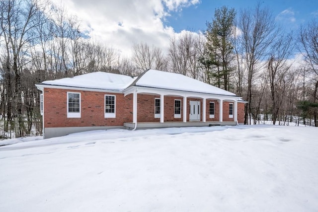 view of front of property with a porch and brick siding