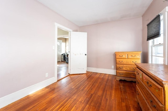 unfurnished bedroom with dark wood-type flooring