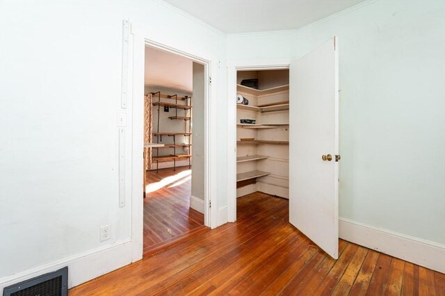 interior space with crown molding and dark hardwood / wood-style floors