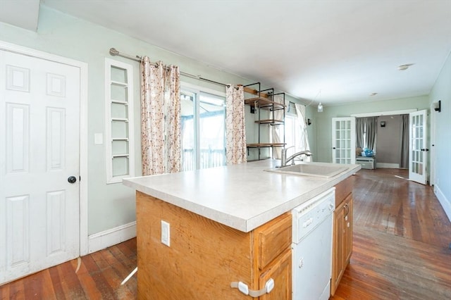 kitchen featuring sink, a kitchen island with sink, white dishwasher, dark hardwood / wood-style flooring, and french doors