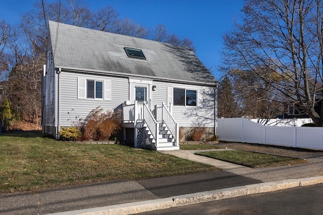 cape cod-style house with a front yard