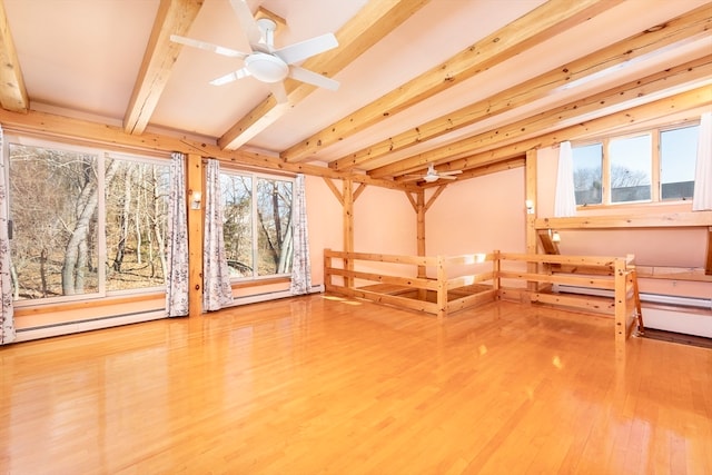 interior space featuring hardwood / wood-style flooring, ceiling fan, and beamed ceiling