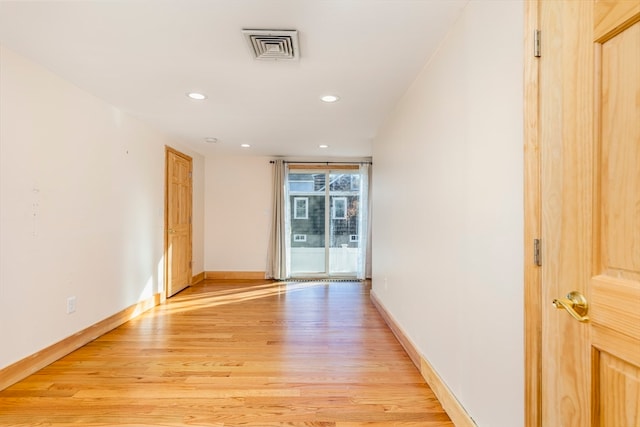 unfurnished room with light hardwood / wood-style floors