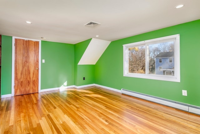 bonus room featuring light hardwood / wood-style flooring and baseboard heating