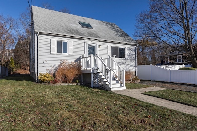 cape cod home with a front lawn