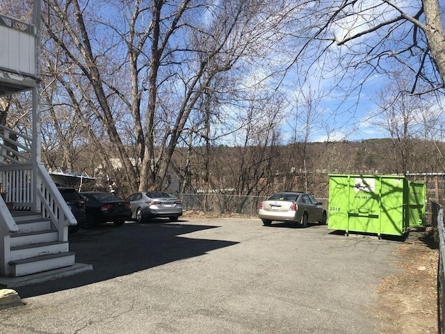 uncovered parking lot with fence and stairway