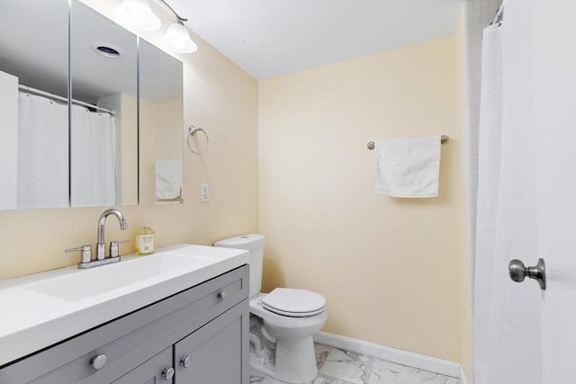 bathroom featuring vanity and toilet