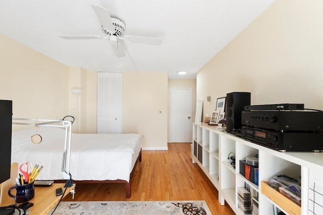 bedroom featuring ceiling fan, a closet, and light wood-type flooring