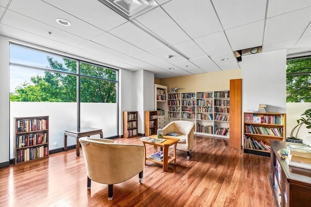 living area featuring wood-type flooring and floor to ceiling windows