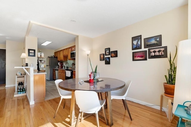 dining space featuring light wood-type flooring