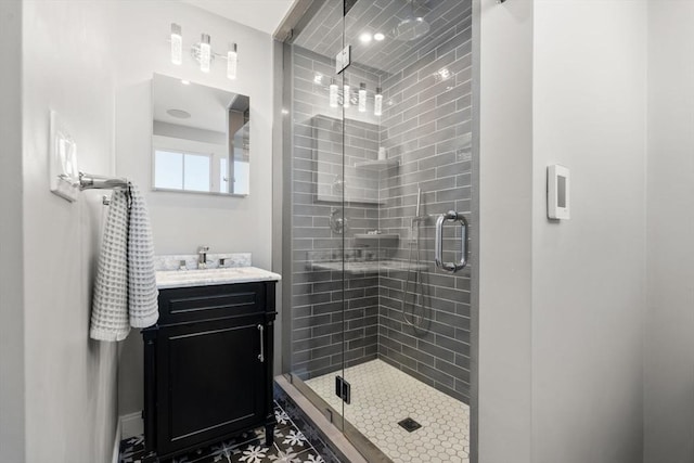 bathroom featuring vanity and a shower with shower door