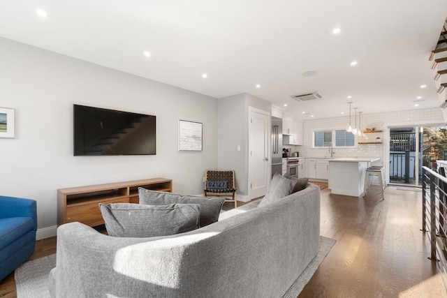 living room with sink and hardwood / wood-style flooring