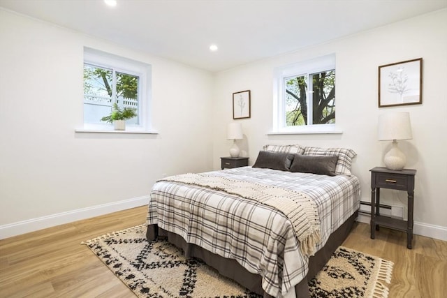 34 Bayview Ter Unit 3, Danvers, MA 01923 - bedroom featuring multiple windows, a baseboard heating unit, baseboards, light wood-type flooring, and recessed lighting