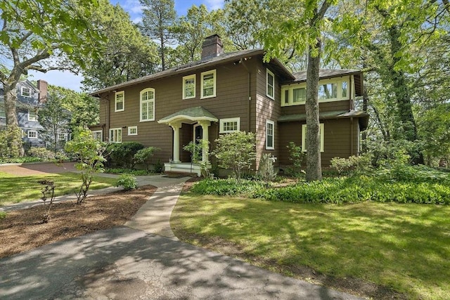 19 Ridge Rd, Newton, MA 02468 - view of front facade featuring a chimney and a front lawn