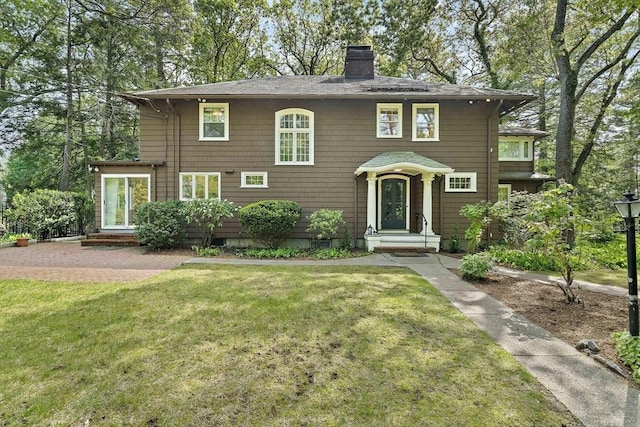 19 Ridge Rd, Newton, MA 02468 - view of front facade with a chimney, a front lawn, and roof with shingles