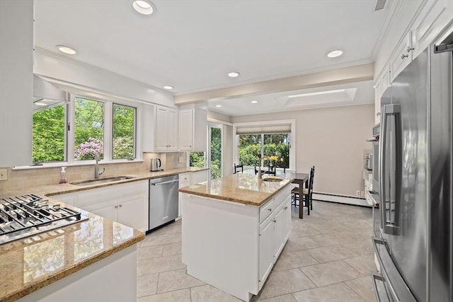 19 Ridge Rd, Newton, MA 02468 - kitchen featuring appliances with stainless steel finishes, a sink, healthy amount of natural light, a center island, and crown molding