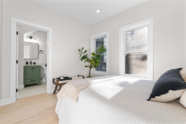 62 Haynes Unit 201, Boston, MA 02128 - bedroom with light wood-style floors, a sink, connected bathroom, and baseboards