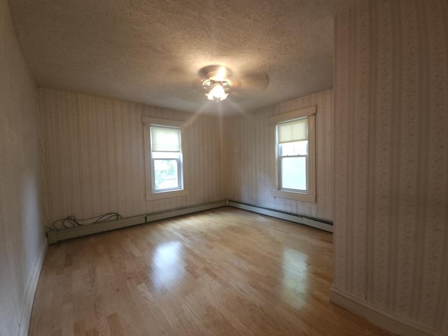 45 Circuit Ave E, Worcester, MA 01603 - empty room featuring wood finished floors, wallpapered walls, a textured ceiling, plenty of natural light, and ceiling fan