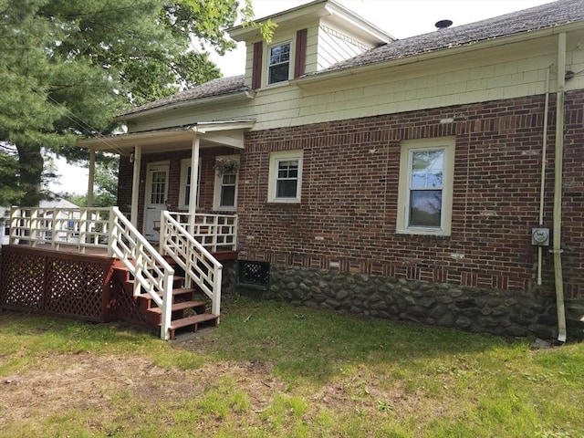 45 Circuit Ave E, Worcester, MA 01603 - rear view of house with brick siding, a lawn, covered porch, and stairway