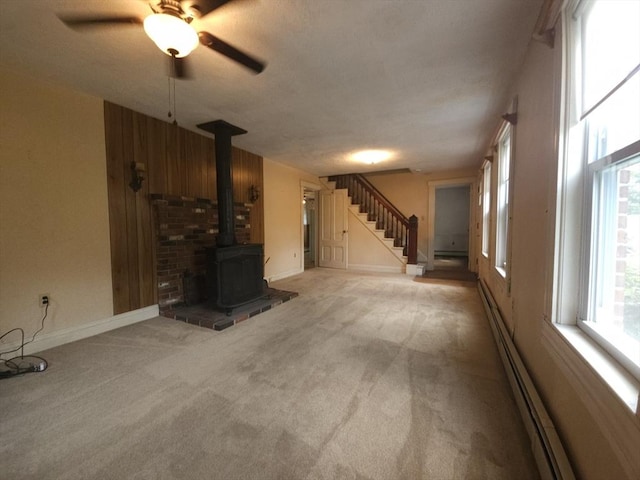 45 Circuit Ave E, Worcester, MA 01603 - unfurnished living room featuring stairs, carpet, a wood stove, and a ceiling fan