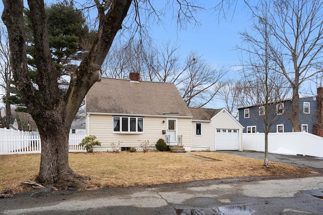 view of front of property with a front lawn, aphalt driveway, fence, an attached garage, and a chimney