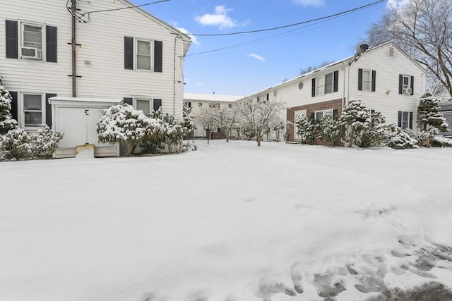 yard layered in snow featuring cooling unit