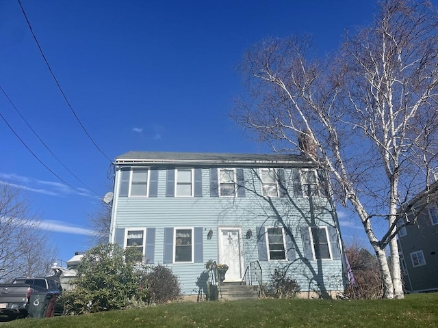 colonial-style house with a front lawn