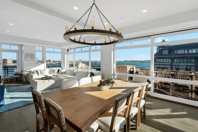 sunroom with a water view and a healthy amount of sunlight