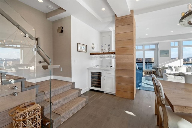 bar with white cabinets, dark wood-type flooring, and beverage cooler