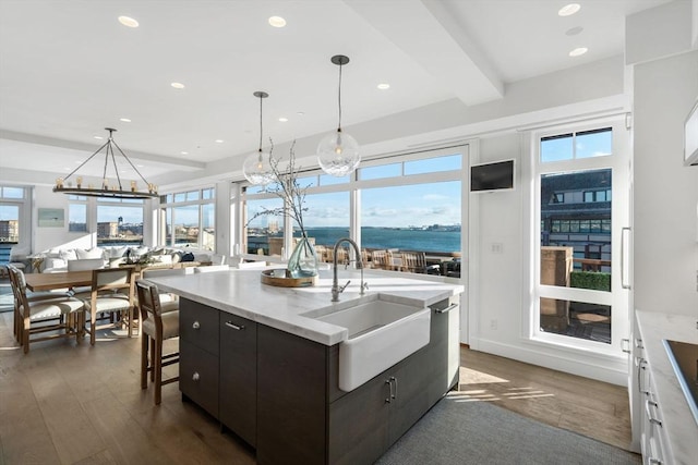 kitchen with white cabinetry, sink, dark wood-type flooring, beamed ceiling, and dark brown cabinets