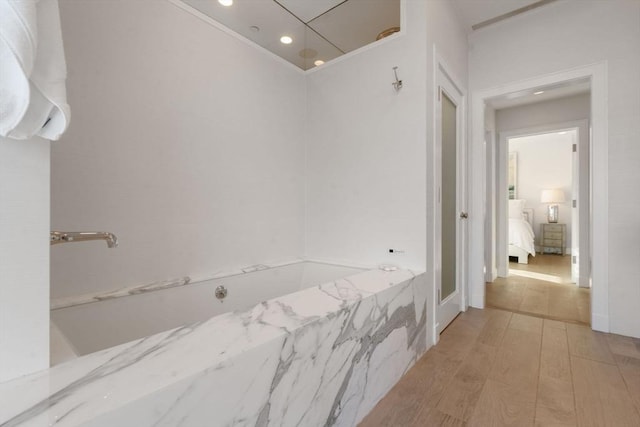 bathroom with hardwood / wood-style floors