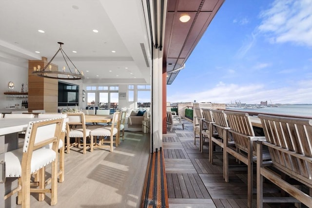 exterior space with light parquet flooring and a water view