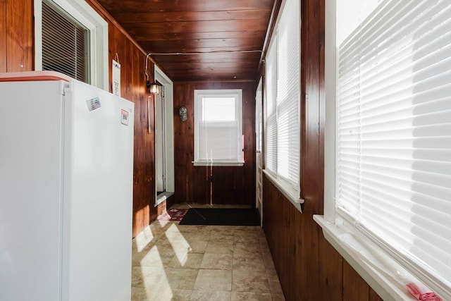 entryway featuring wooden walls and wood ceiling