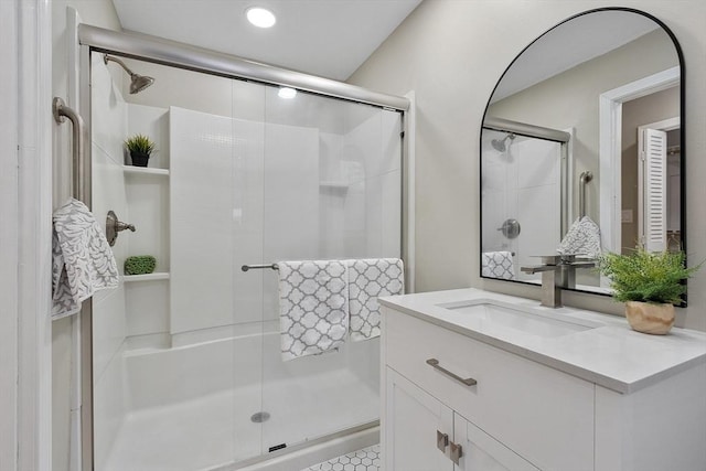 bathroom featuring vanity and a shower stall