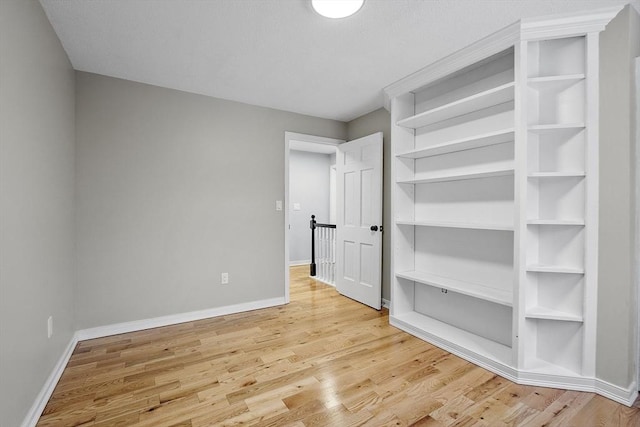 unfurnished bedroom with baseboards and light wood finished floors